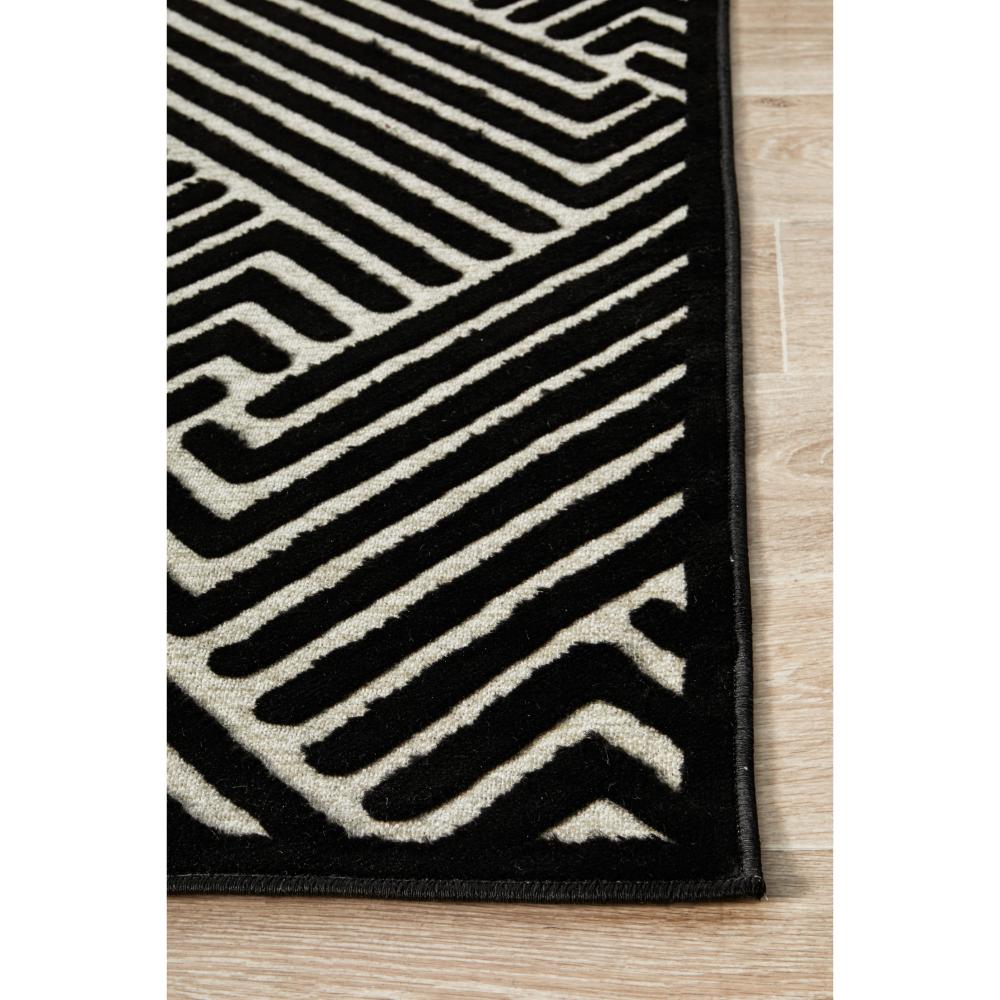 black and beige chevron patterned rug detail image - House