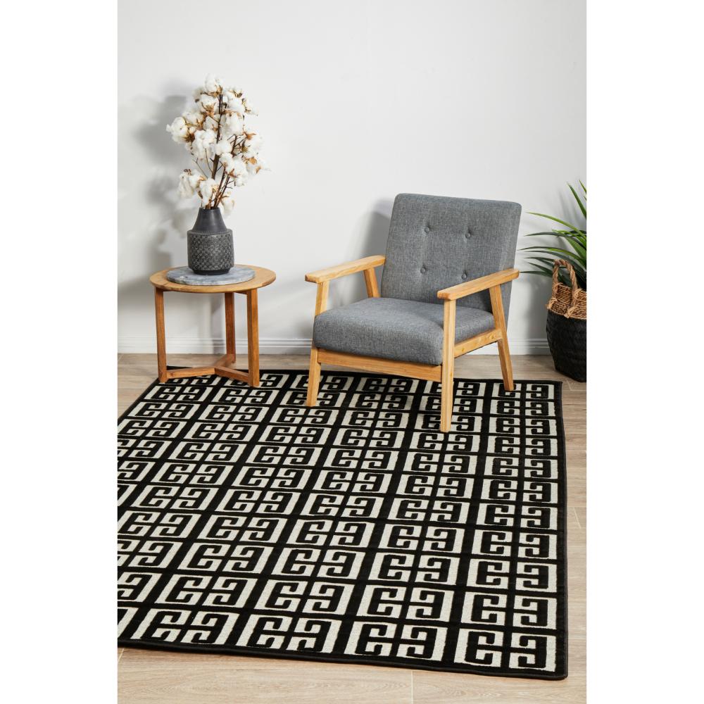 black and beige art deco tile rug with armchair and table - House