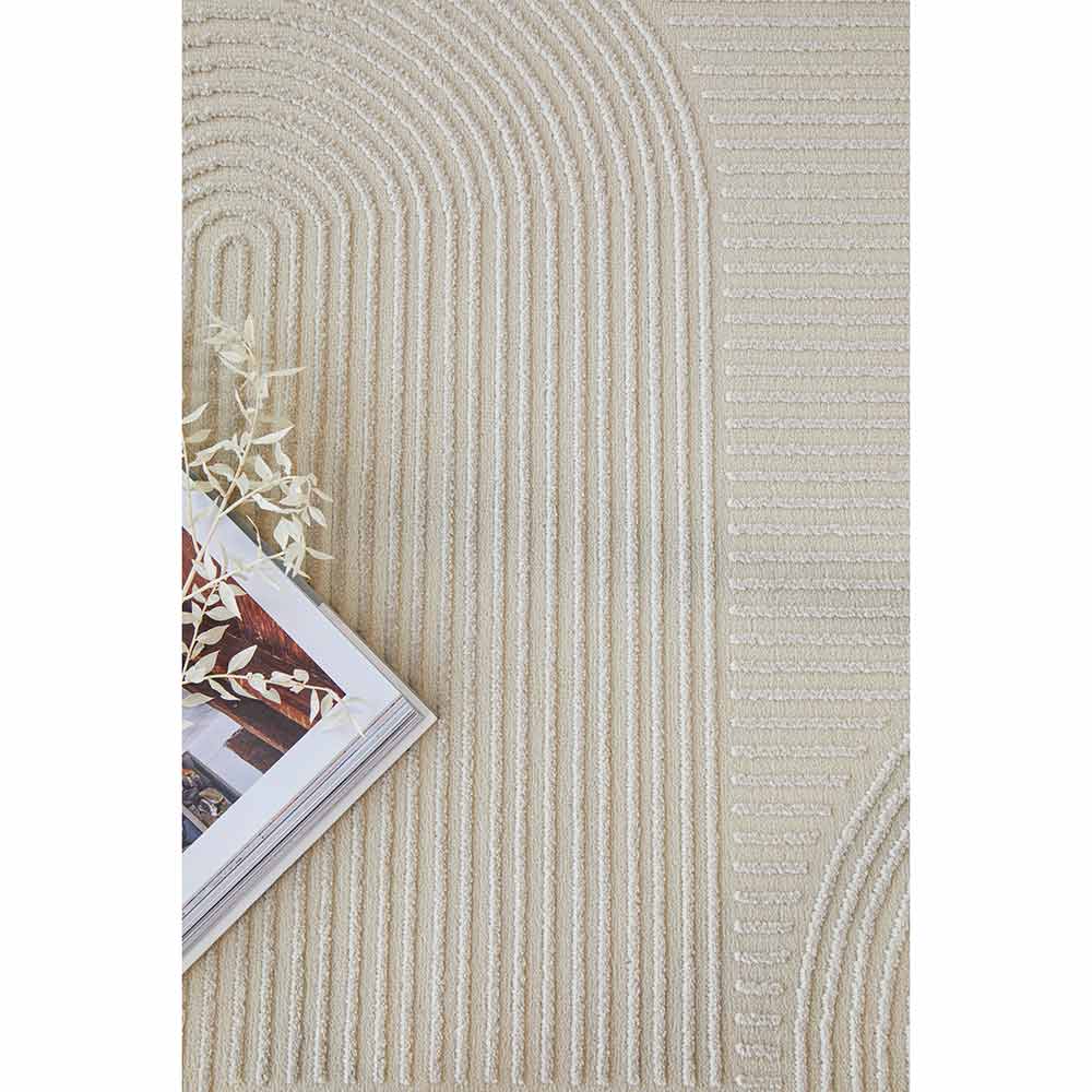 Darren Palmer Raking Rug Linen Cream with a magazine at House