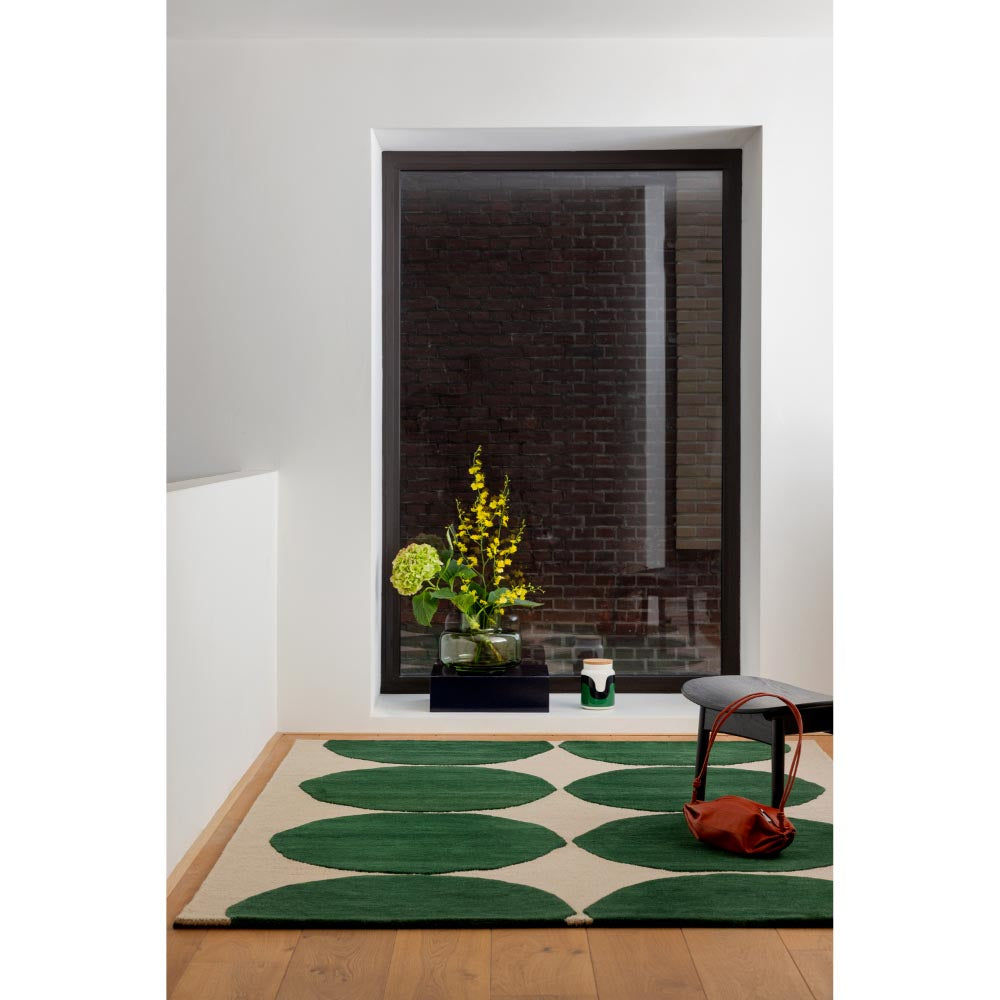 Marimekko Isot Kivet Rug Green. Cream rug with green dots in a hallway