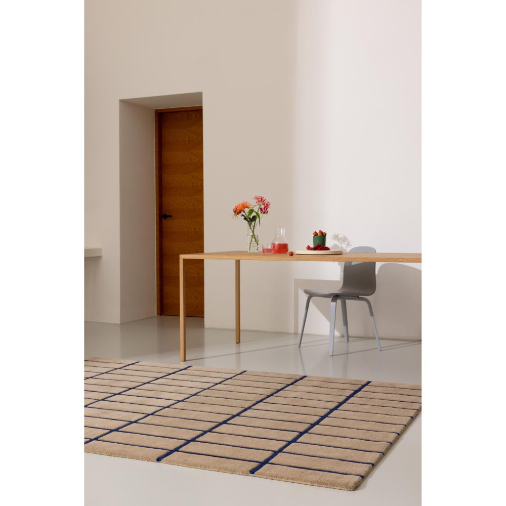 Marimekko Tiiliskivi Rug Bright Blue. Brown rug with blue line grid