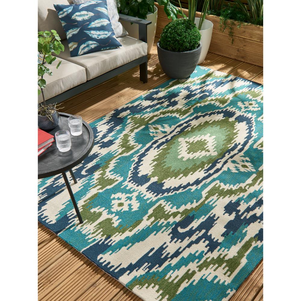 Blue, green aztec Indoor/Outdoor Rug in outdoor sitting area - House