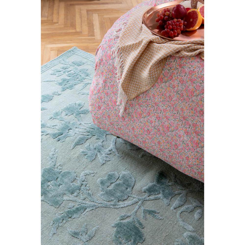 sage green flower embossed rug under pink floral bed - House