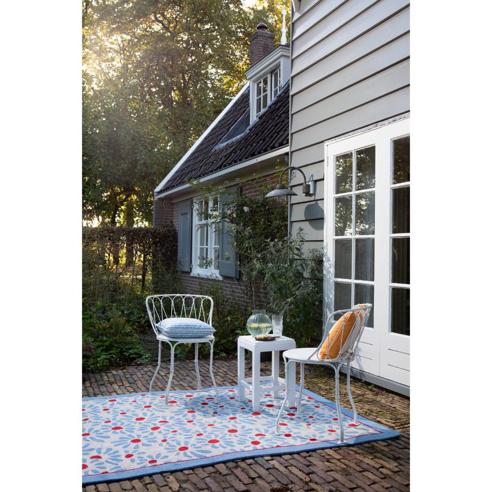 Blue daisies outdoor rug in backyard with setting - House