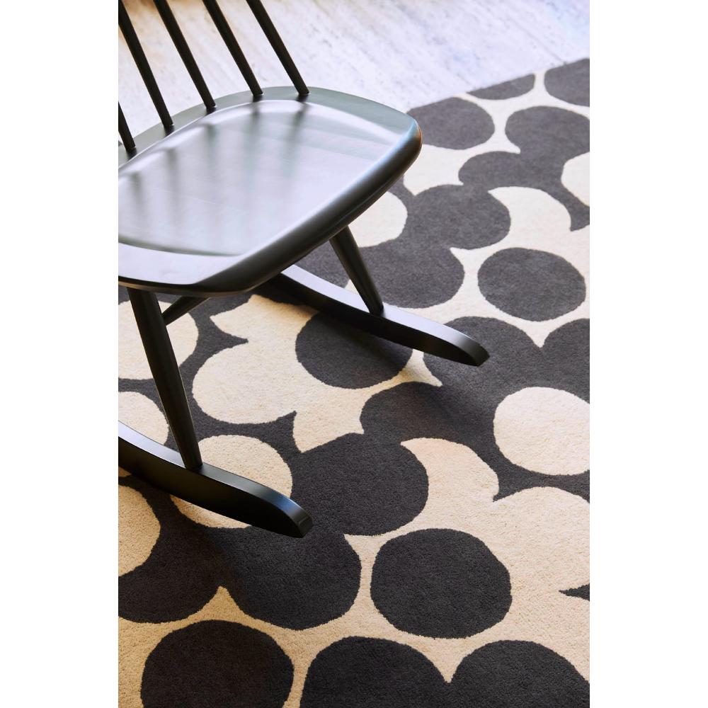 Grey and white flower rug with wooden rocking chair - House