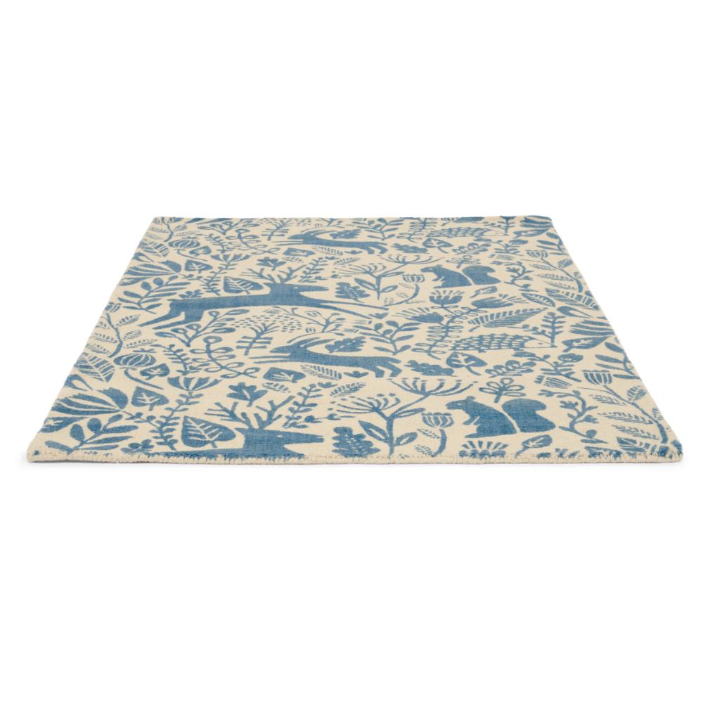 blue printed woodland creatures wool rug angled image - House