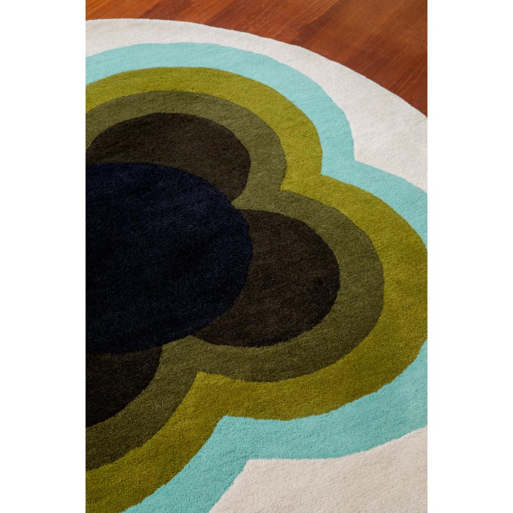 round green and blue flower rug on wooden floor - House