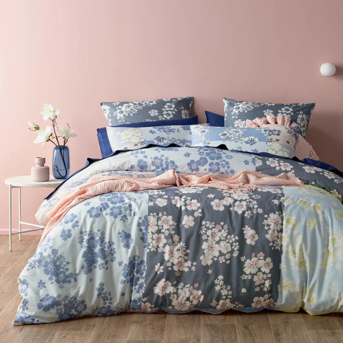 Floral bedding set on a bed with a pink wall in the background