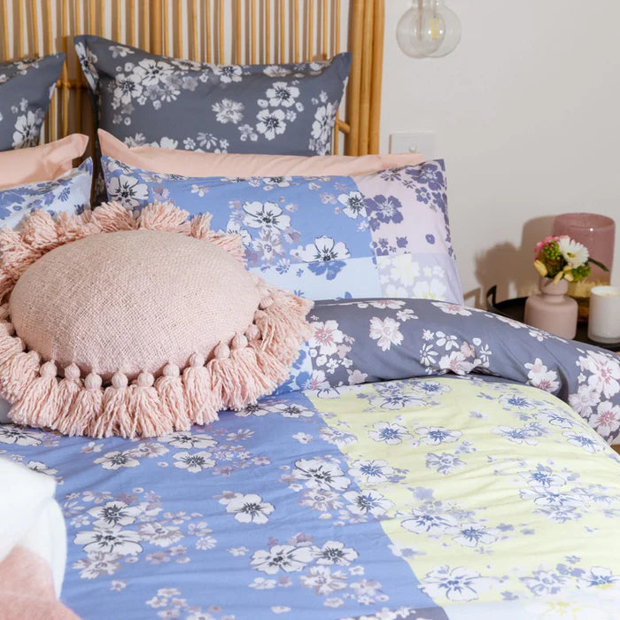 Floral bedding set with a pink pillow on a bed