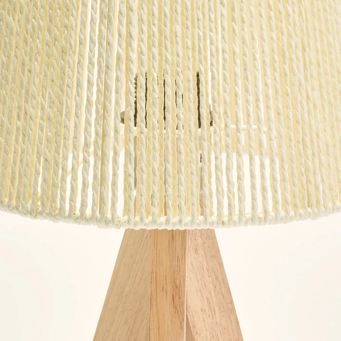 Close-up of a woven lampshade with wooden base on a white background