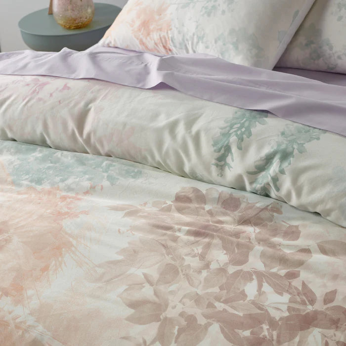 Floral patterned bedding set on a bed with a blurred background