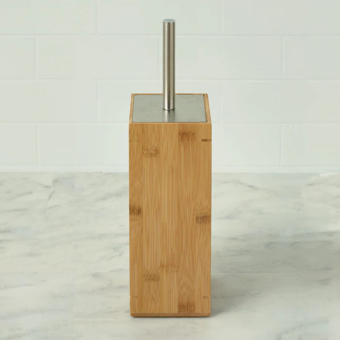 Bamboo toilet brush holder with metal brush on a marble surface