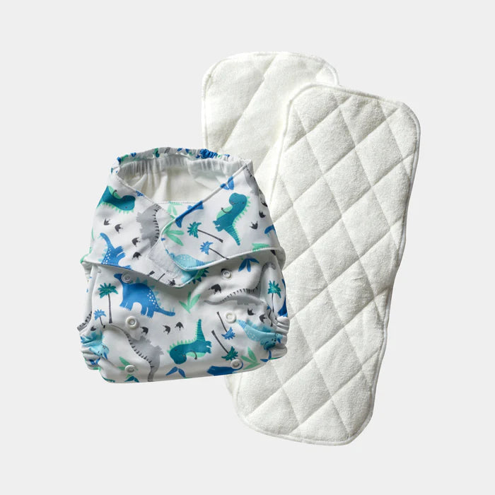 Baby diaper with dinosaur pattern and matching quilted cover on a light gray background