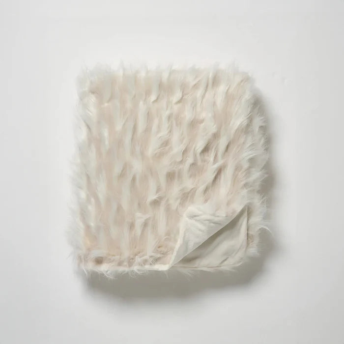 Beige fur blanket on a white background