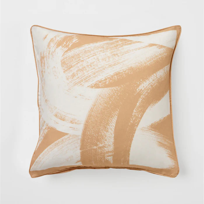 Decorative pillow with abstract brown and white design on a light gray background