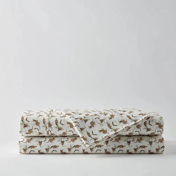 Folded bed sheets with animal pattern on a light gray background