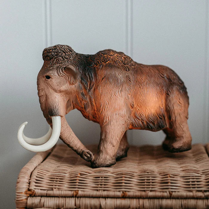 Model of a woolly mammoth on a wicker surface with a neutral background