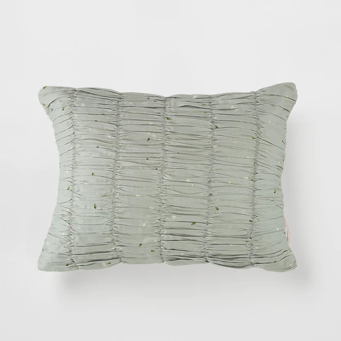 Textured green pillow on a white background