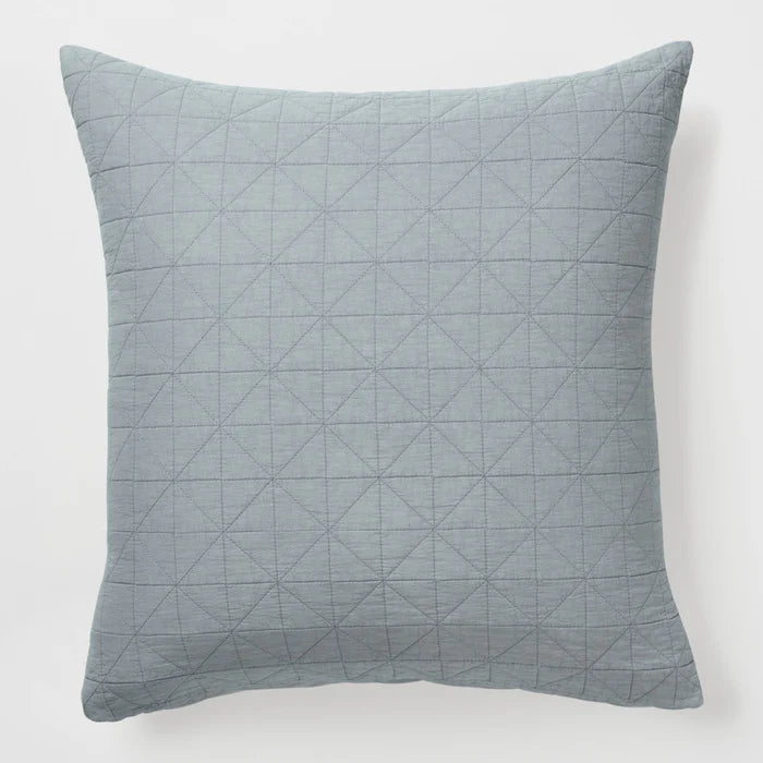 Quilted gray pillow on a white background