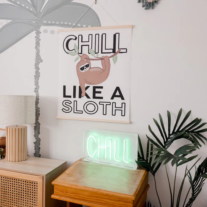 Room interior with 'Chill Like a Sloth' poster and neon sign.