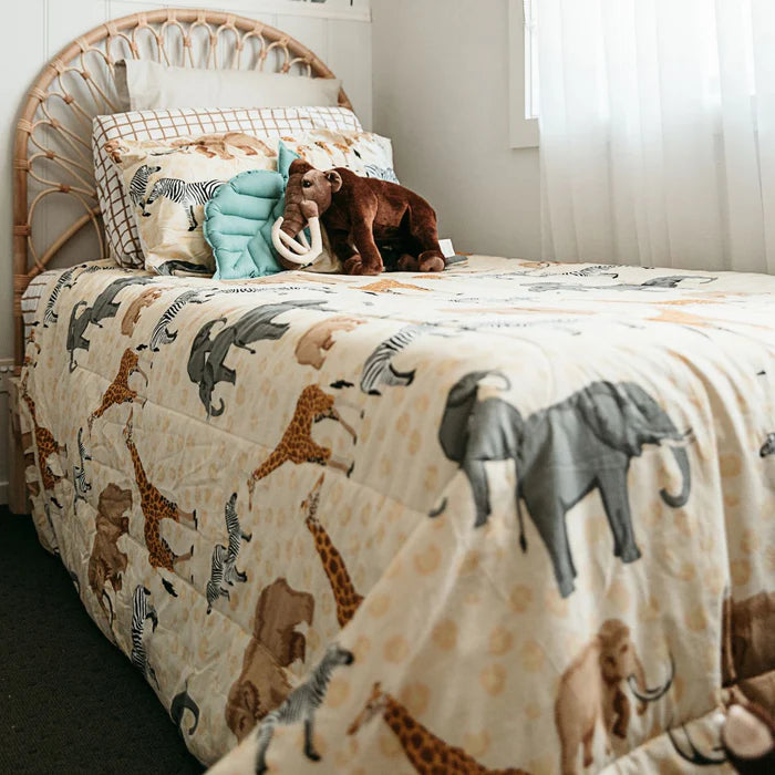 Bed with animal-patterned bedding and stuffed animals in a child's bedroom.