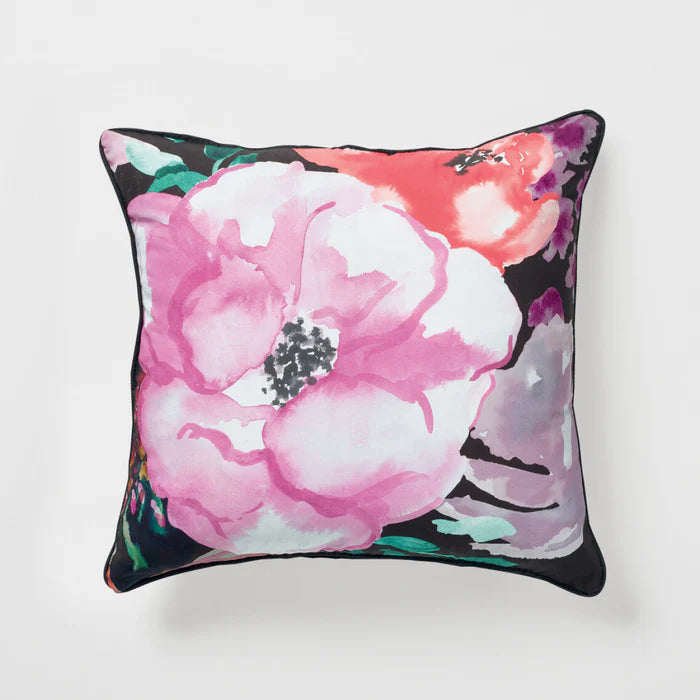 Floral pillow with pink and white flowers on a black background